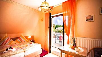 A bedroom with a bed, a table with fruit, a chair, a window with curtains, and a view of the outside.