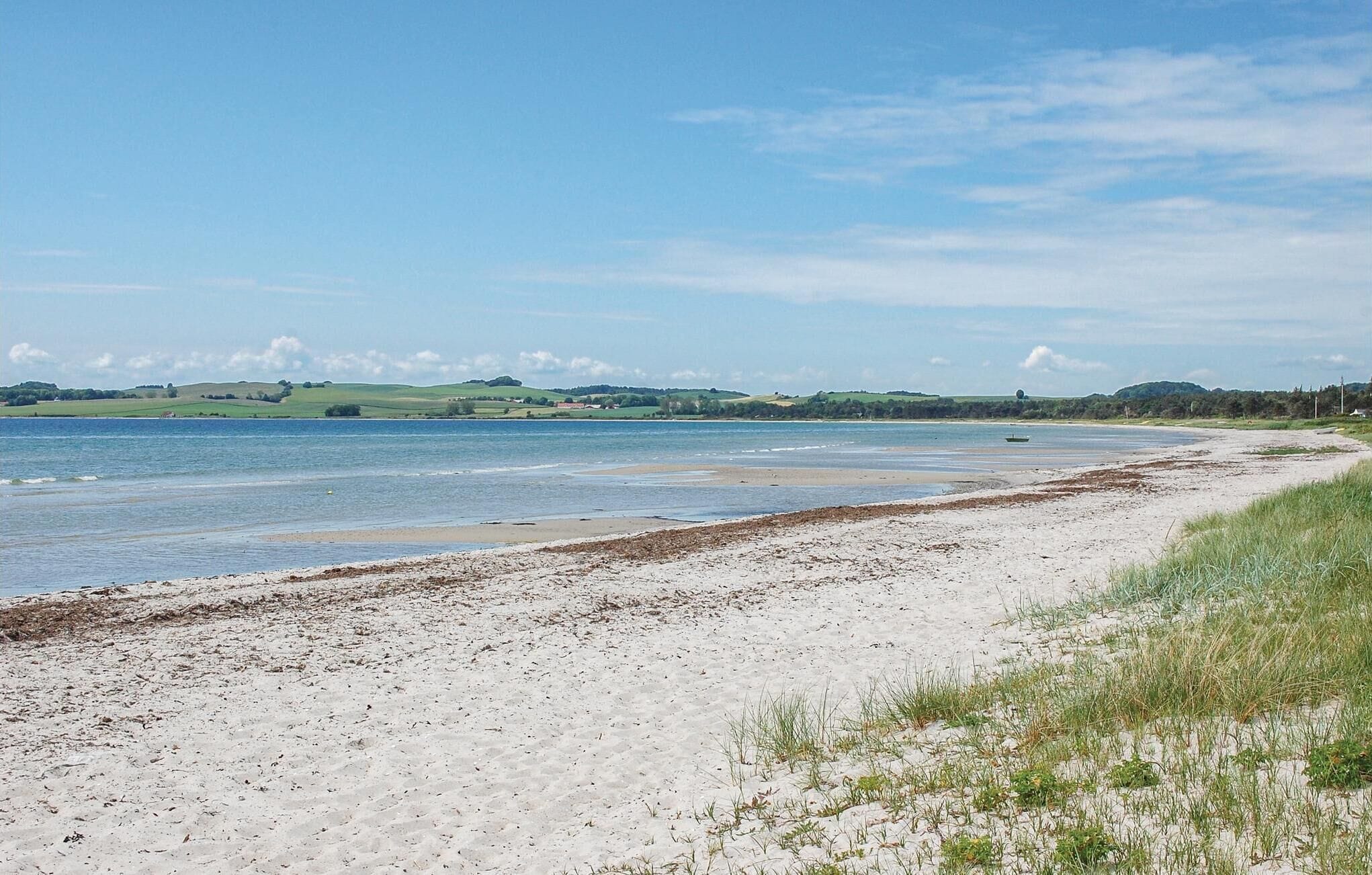 A coastal beach with a sandy shore and a calm sea.