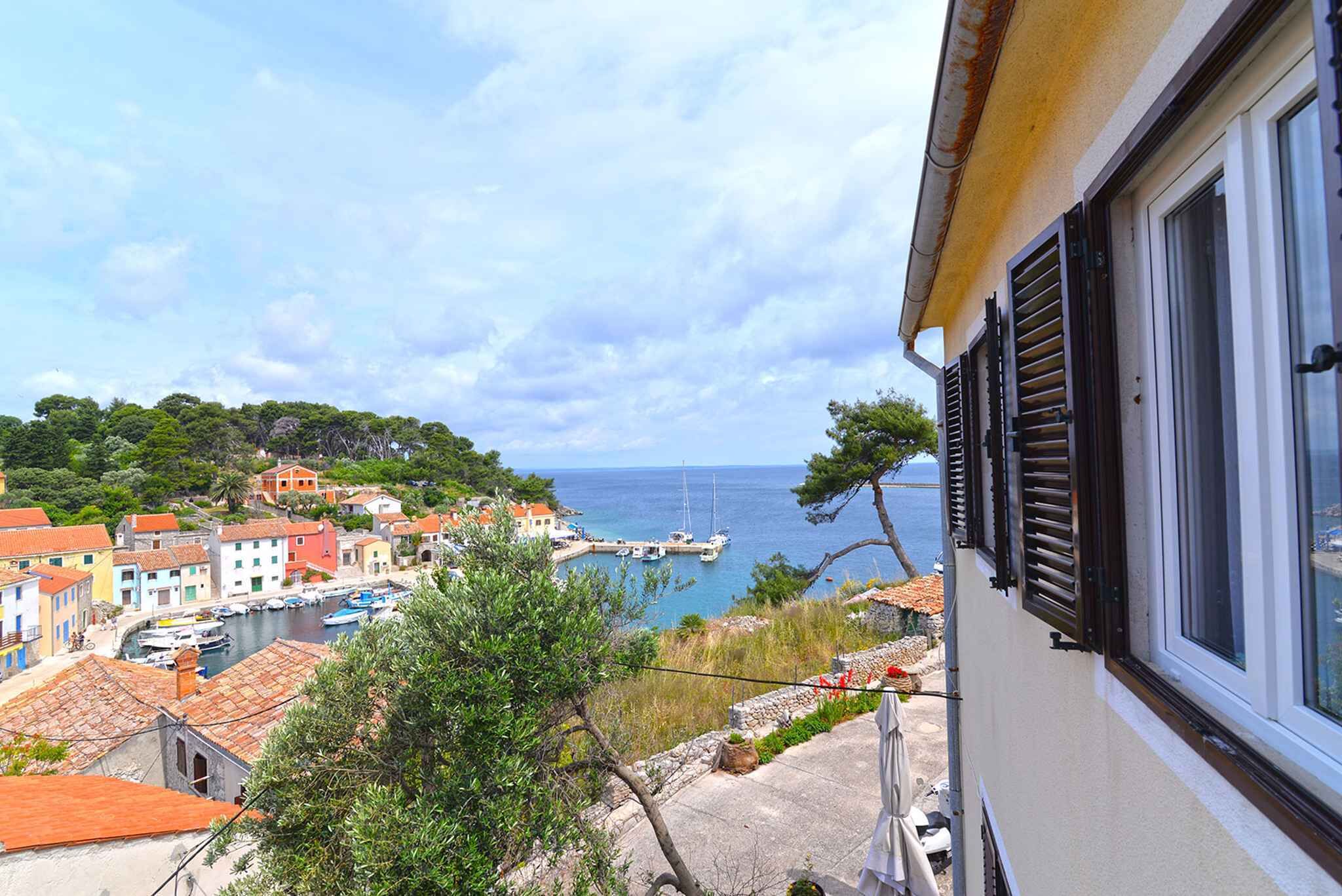 A coastal town with colorful buildings, a marina, and a view of the sea.