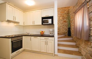 Fridge, stovetop, dishwasher, coffee/tea maker