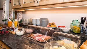 A buffet with various food items including fruits, cheeses, and meats. - Apartment 16 - Liedschreiber GbR Guesthouse and Vacation Rentals (Kreuth)