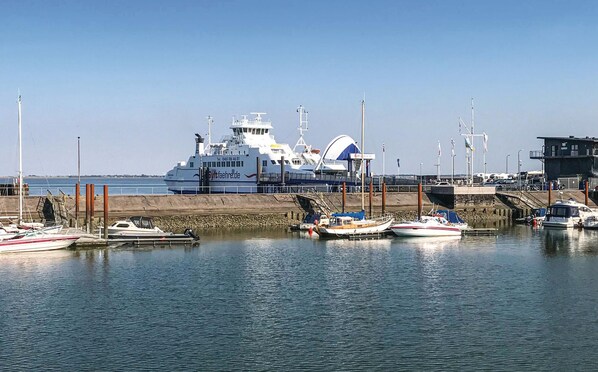 Harbor views surround this waterfront property, offering a ferry docked at the pier with a ramp for easy access.