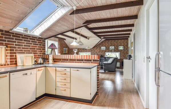 Enjoy cooking in this well-equipped kitchen with a large island, sink, and refrigerator.