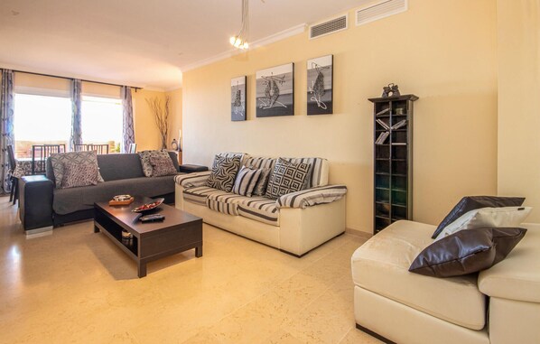 A living room with two sofas, a coffee table, and a bookshelf. - Awesome apartment in Elviria with WiFi (Elviria)