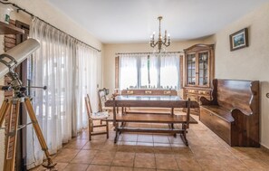 Enjoy stargazing from the comfort of your room, where a telescope and traditional dining area invite relaxation.