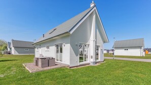 A small, single-story house with a gabled roof and a front porch.