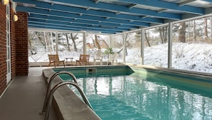 An indoor swimming pool with a view of a snowy landscape through large windows. - Awesome home in Rømø with kitchen (Rømø)