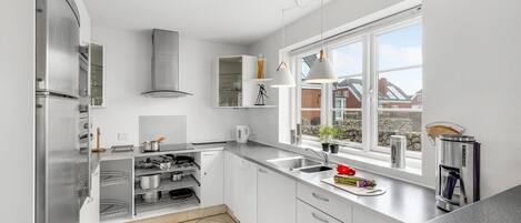 Fridge, stovetop, dishwasher, coffee/tea maker