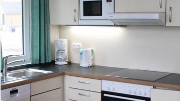 Fridge, stovetop, dishwasher, coffee/tea maker