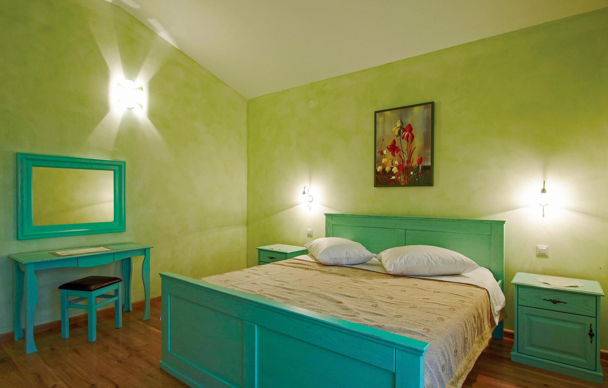 A room with a bed, a desk, and a chair.