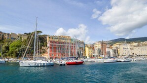 A marina with boats docked, colorful buildings, and a clear sky. - 1 bedroom nice apartment in Bastia (Bastia)