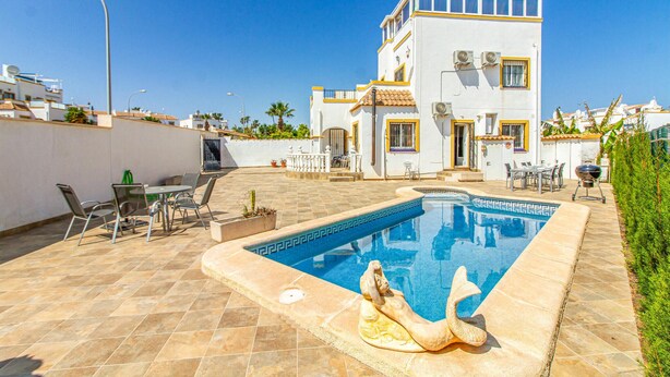 A two-story building with a swimming pool, outdoor seating, and a statue. - Amazing home in Orihuela Costa (Orihuela Costa)