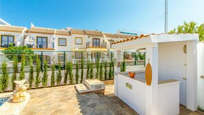 A patio area with a pool, outdoor seating, and a small bar area. - Amazing home in Orihuela Costa (Orihuela Costa)