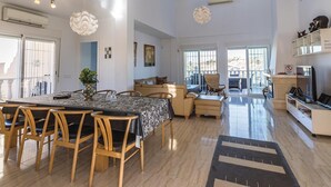 A spacious living area with a dining table, chairs, a sofa, and a television. - Amazing home in Ciudad Quesada-Rojales (Ciudad Quesada-Rojales)