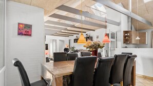 A modern dining area with a wooden table, black chairs, and pendant lights. - Amazing home in Oksbøl with sauna (Oksbøl)