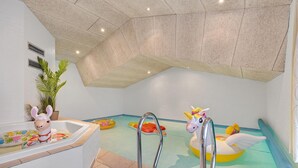 A children's play area with a pool, inflatable toys, and a bathtub with a toy. - Amazing home in Oksbøl with sauna (Oksbøl)