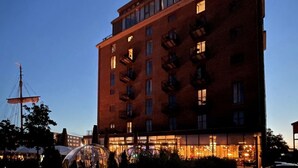 A multi-story building with a brick facade, large windows, and balconies. - Ohlerich storage app. 44 - Ohlerich Speicher App. 44 (Wismar)