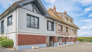 A two-story house with a garage, a brick foundation, and a sloped roof. - Cozy home in Villers-S/s-Foucarmont (Villers-S/s-Foucarmont)