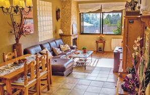 Cozy living room with a comfortable seating area, fireplace, and large window.