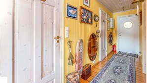 A hallway with wooden doors, a nautical-themed wall, and a patterned rug. - Amazing home in Hundeidvik with ethernet internet (Hundeidvik)