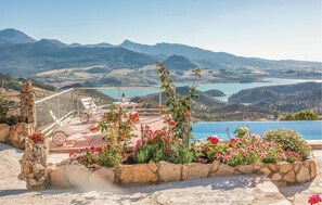 A poolside area with a view of mountains and a lake. - Awesome home in Cádiz (Cádiz)