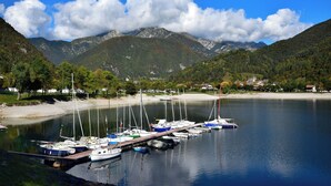A marina with boats docked, surrounded by mountains and a clear sky. - Holiday apartment with balcony and mountain view (Locca)