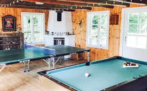 Relax by the fireplace and enjoy games in the spacious room with a pool table and billiards table.