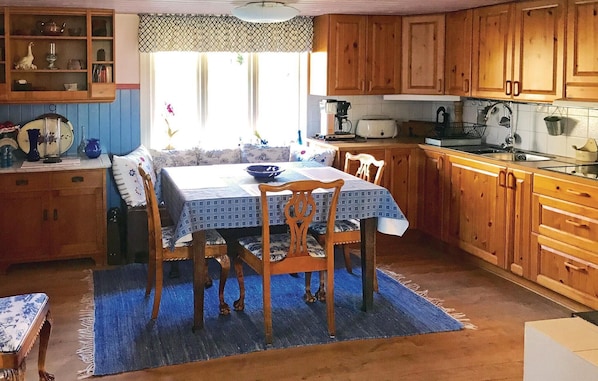 Enjoy meals in the kitchen with a stove, sink, and dining area featuring a table and chairs.