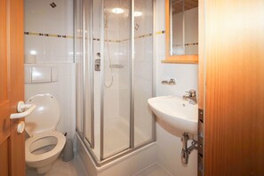 Shower, hair dryer, towels, toilet paper