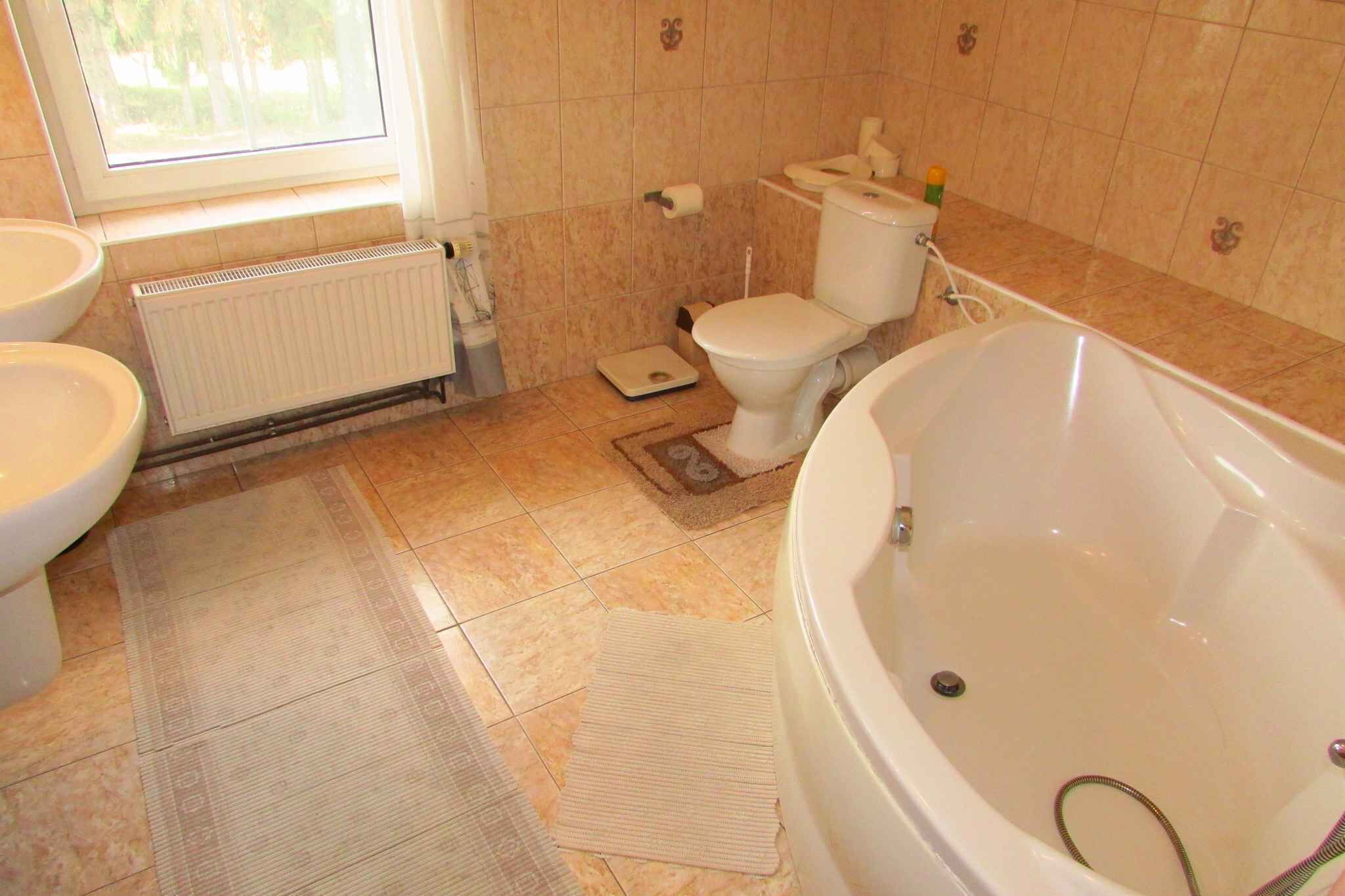 A bathroom with a bathtub, toilet, and sink.