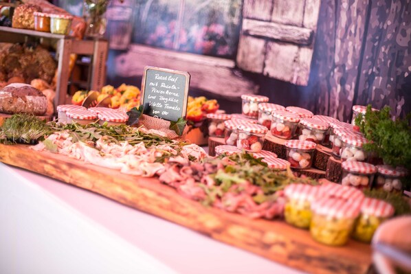 A charcuterie board with various meats, cheeses, and pickles.