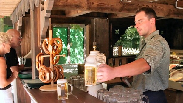 A bar area with pretzels, beer mugs, and a large beer mug on the counter.