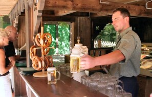 A bar area with pretzels, beer mugs, and a large beer mug on the counter.
