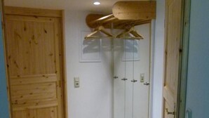 A room with a wooden door, a glass shower enclosure, and a wooden floor. - Apartment (DG) - Old rectory Rappin (Rappin)