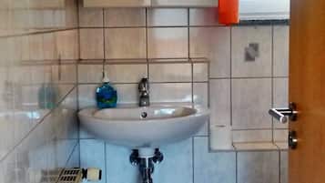 Een haardroger, handdoeken, zeep, toiletpapier