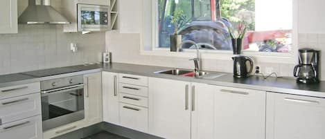 Fridge, stovetop, dishwasher, coffee/tea maker
