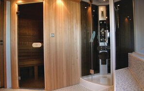 A sauna with a wooden interior and a glass-enclosed shower area. - Awesome home in Poperinge with sauna (Poperinge)