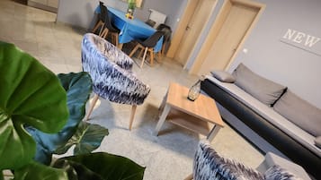 Departamento Confort (1) | Área de sala de estar | Televisión de pantalla plana y piso con calefacción