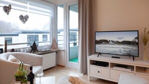 A modern living room with a television, sofa, and coffee table.