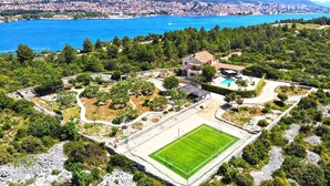 A residential area with a large house, a swimming pool, and a soccer field. - Pet friendly home in Jadrija with sauna (Jadrija)