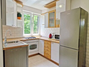 Fridge, stovetop, dishwasher, coffee/tea maker