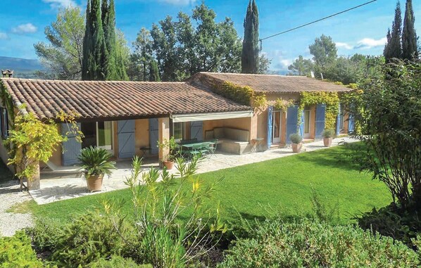A two-story house with a tiled roof, a covered patio, and a well-maintained lawn. - Amazing home in Tourrettes (Tourrettes)