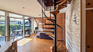 A modern interior with a wooden staircase, a dining area, and a view through large glass doors. - Amazing home in Langelsheim with WiFi (Langelsheim)