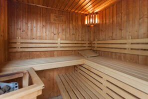 A sauna with wooden benches and a sign on the wall. - Double room with pet (pet included in the price) - Hotel Meerzeit with (Binz)