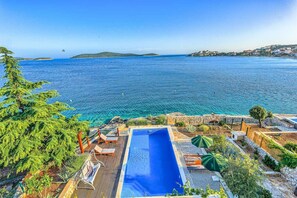 A heated pool, sun loungers