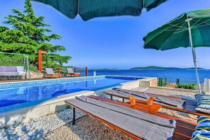 A heated pool, sun loungers