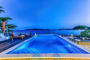 A heated pool, sun loungers
