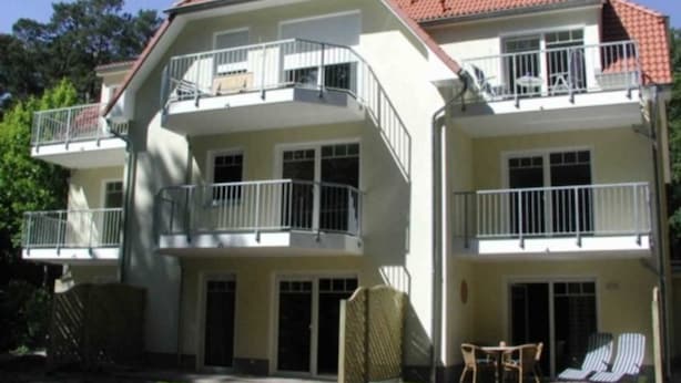 A two-story building with balconies, large windows, and a red-tiled roof. - *Forest 10 measure GM 69552 - Forest 10 - SNR: 1 (Graal-Müritz)