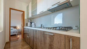 Una cocina moderna con estufa a gas, cafetera y microondas.