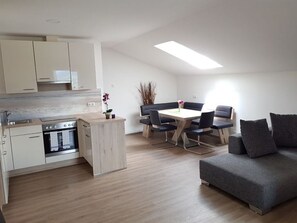 Una cocina moderna con comedor y sofá.